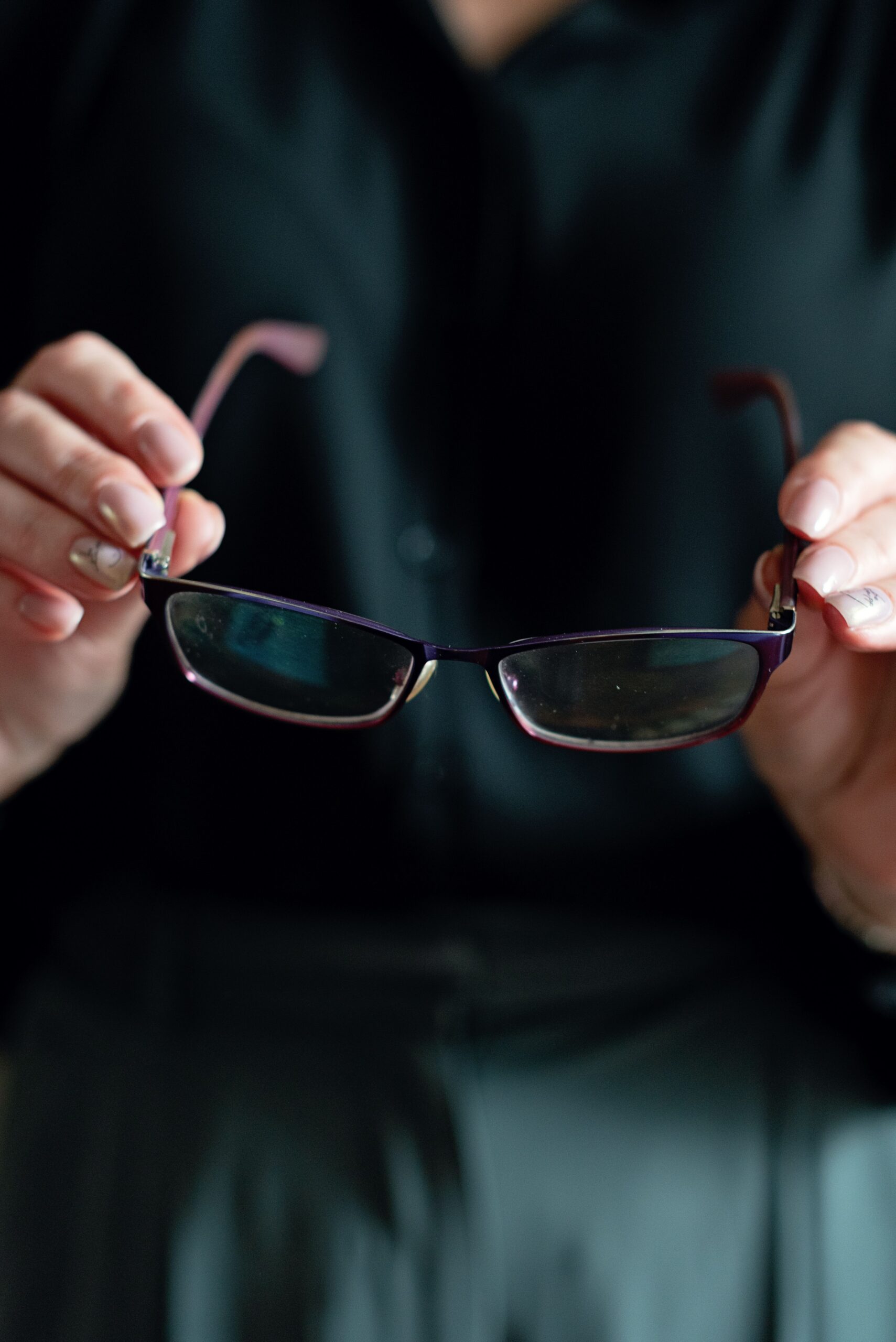 woman holding glasses