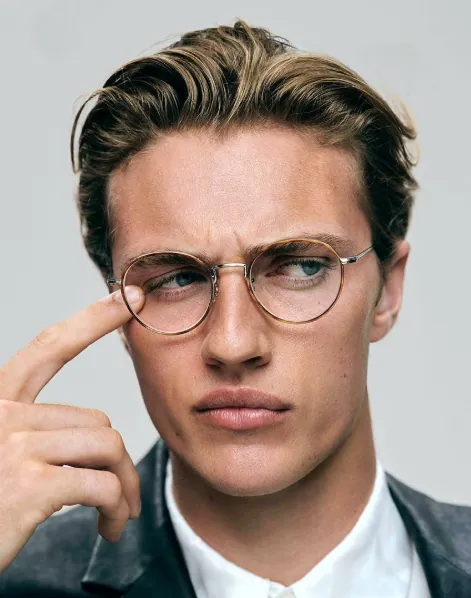 Man wearing round gold wire Oliver Peoples frames