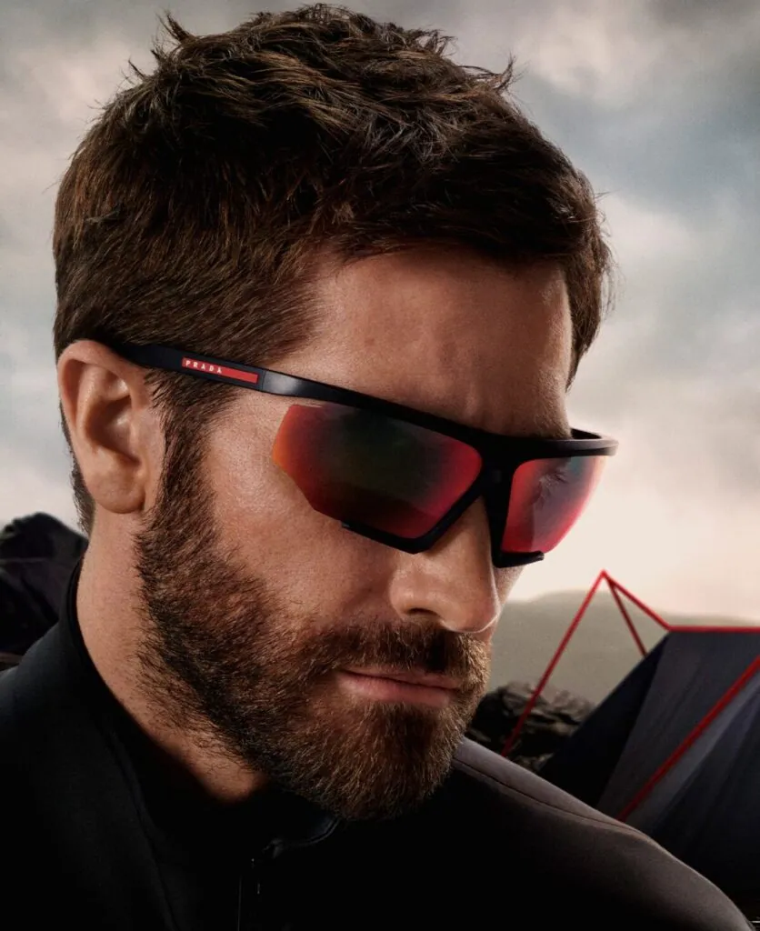 Bearded man wearing Prada black wraparound sunglasses with red lenses