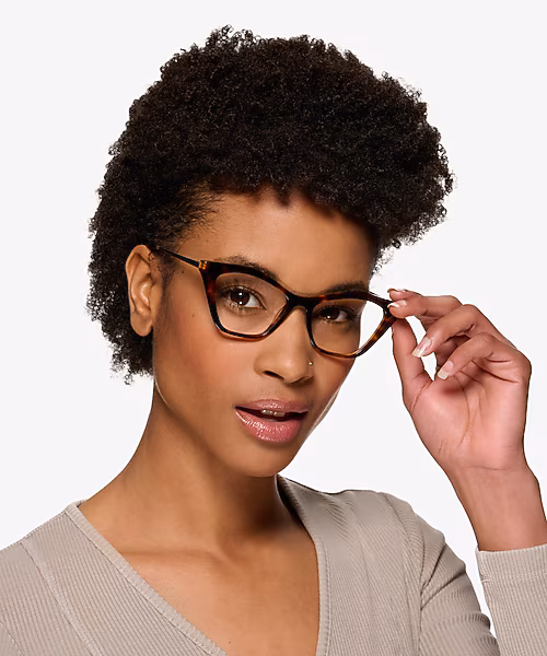 Woman adjusting black cat-eye Tiffany & Co. frames
