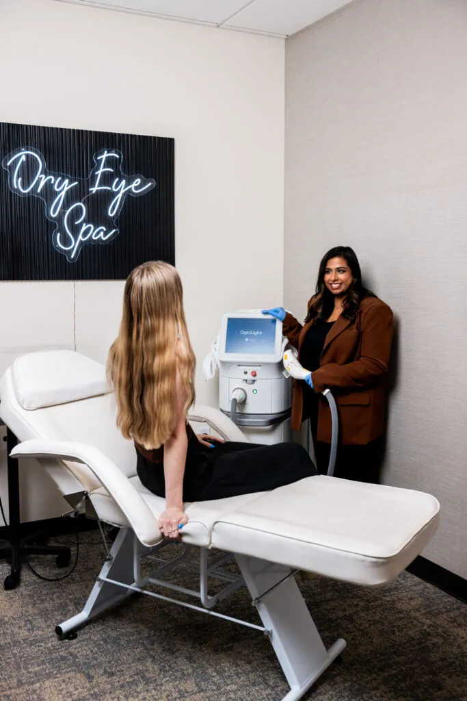 A Village Vision Center doctor treating a patient with OptiLight in the practice’s Dry Eye Spa