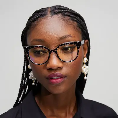 Woman wearing speckled black-and-white cat-eye Kate Spade frames