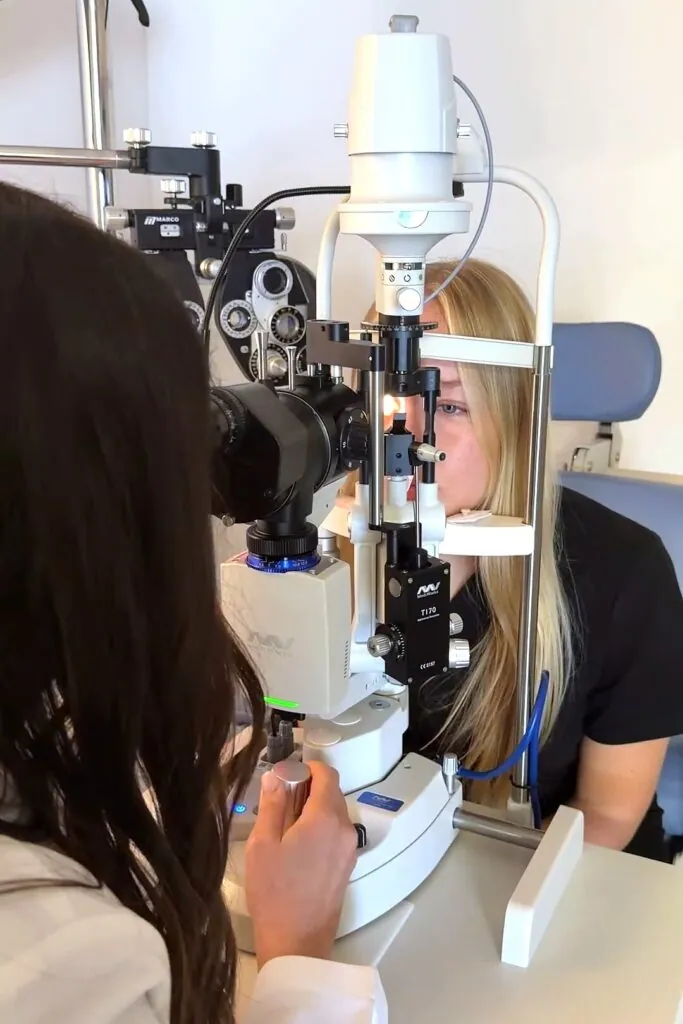 A doctor examining a patient's eye at the slit lamp fitted with the MediWorks Firefly camera
